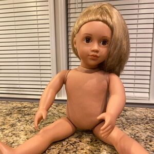 Our Generation 18” Doll with blonde hair and brown eyes.